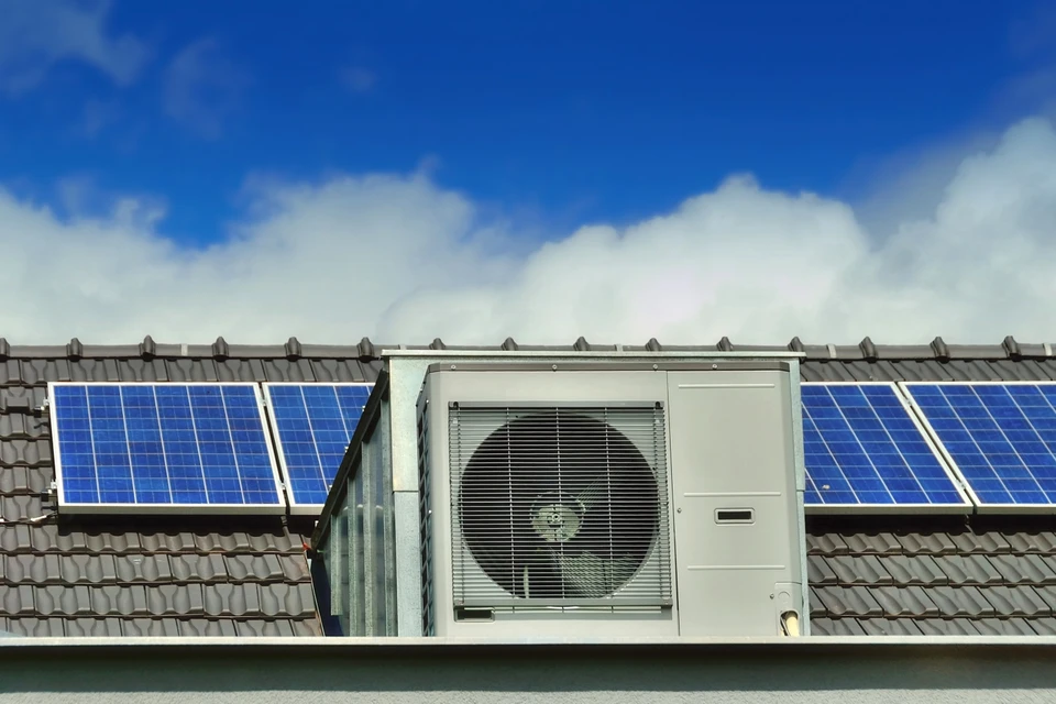 Pompe à chaleur et panneaux solaires sur un toit de maison familiale